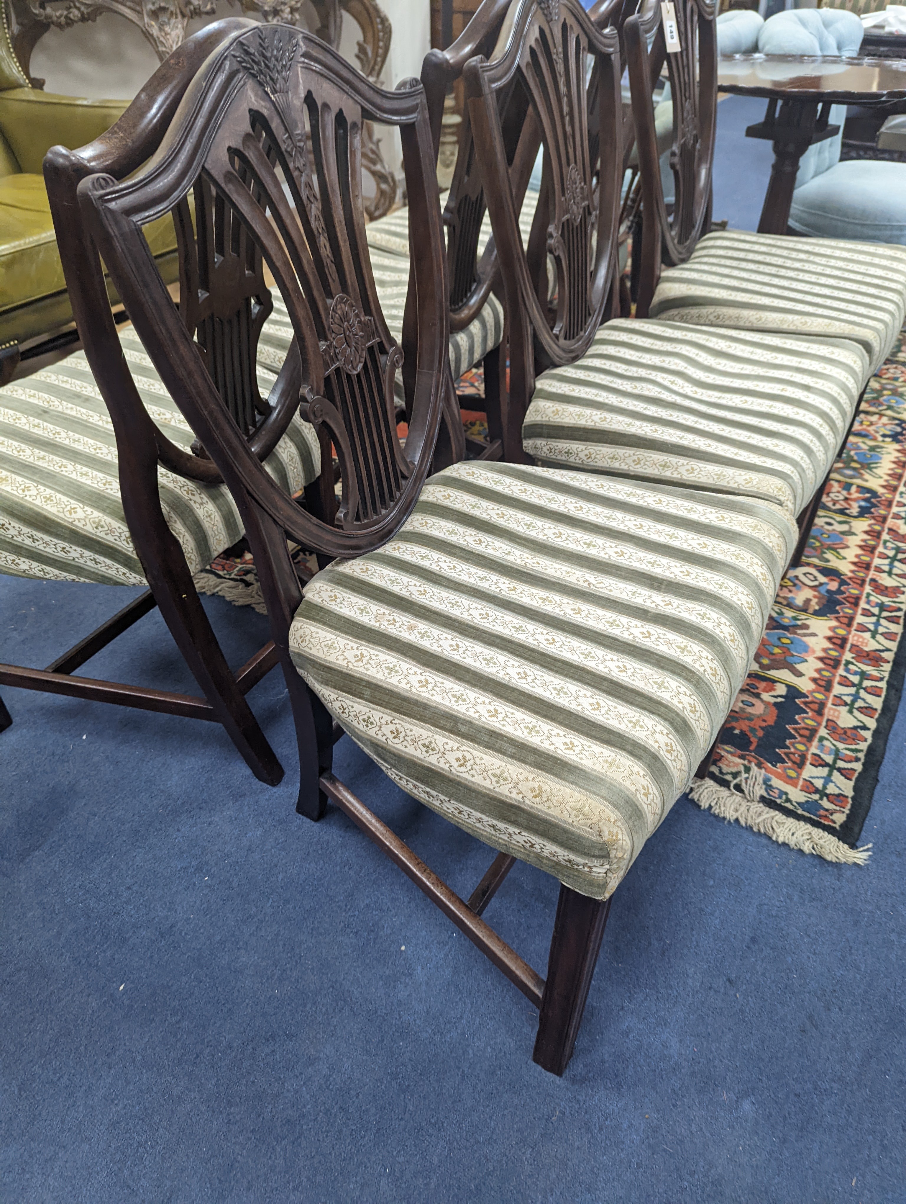 A set of six Sheraton style mahogany dining chairs with shield backs on square tapered legs